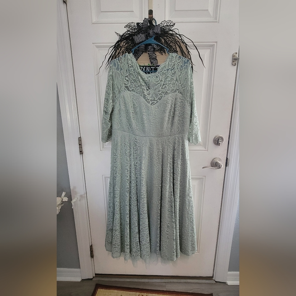 Torrid tea-length dress with fitted waist and tulle underlay.